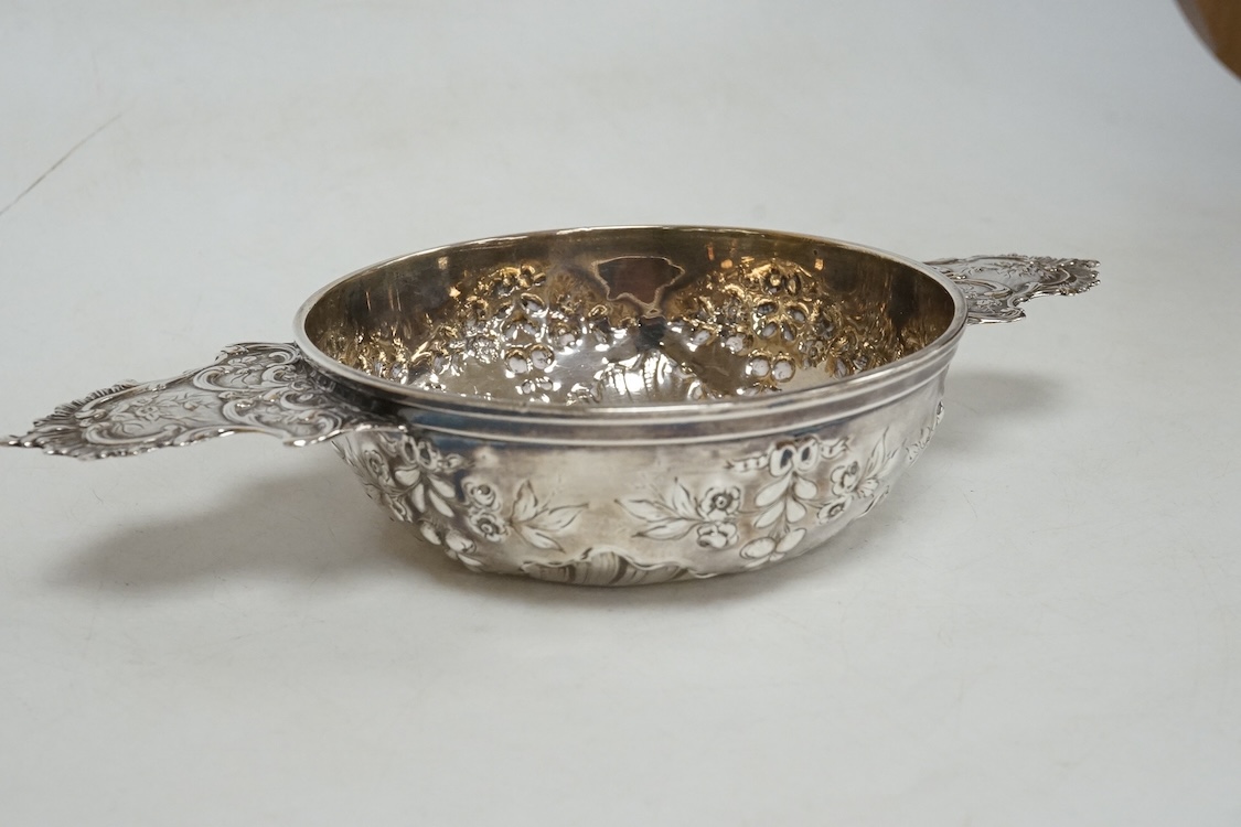 An early 20th century French 950 standard white metal taste vin, embossed with foliage, 20cm, over handles, 4.5oz.